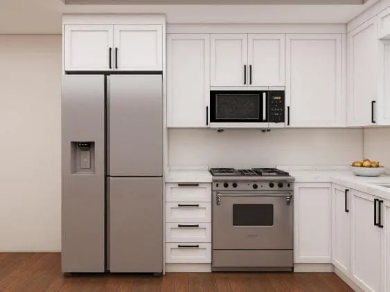 Stainless French-door refrigerator and range set into white Shaker cabinets with a microwave above the range