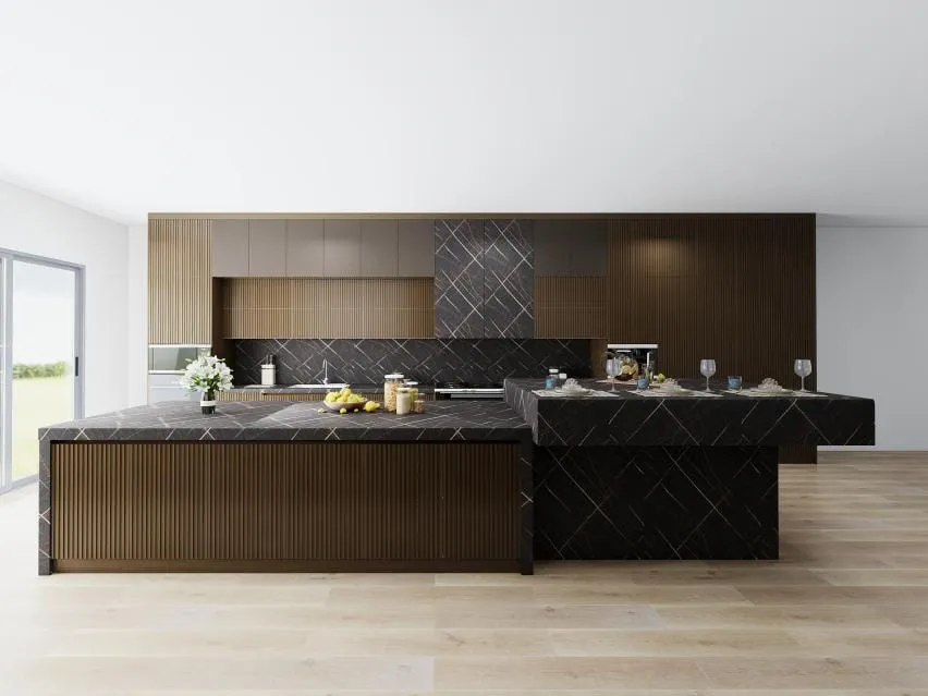 Walnut fluted island with a black veined stone top and a lower waterfall section in an open kitchen