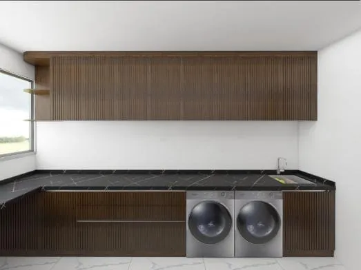 Walnut fluted cabinets with a black stone counter over a side-by-side washer and dryer
