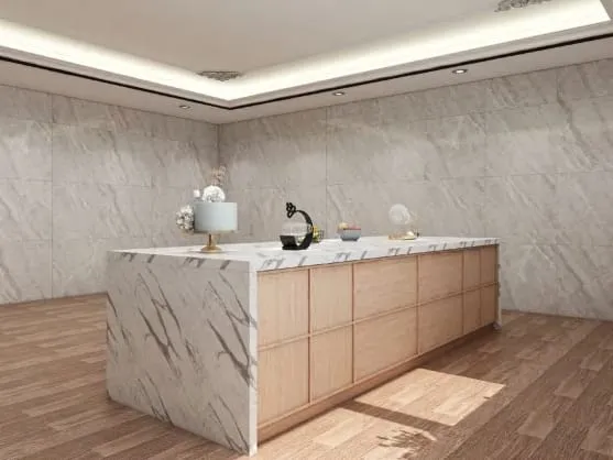 Side view of a white veined stone waterfall island on a wood plank floor