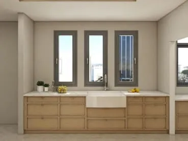 Oak base cabinets with a white farmhouse sink under three narrow windows