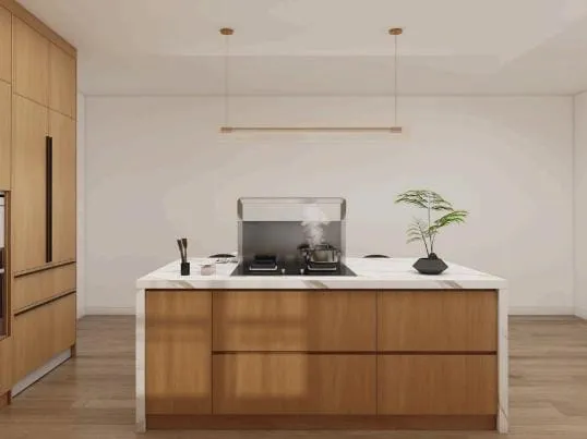 Oak island with a white stone top and cooktop under a brass linear pendant