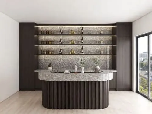 Dark cabinet wall with backlit open shelves, a gray stone backsplash and a curved island with fluted base
