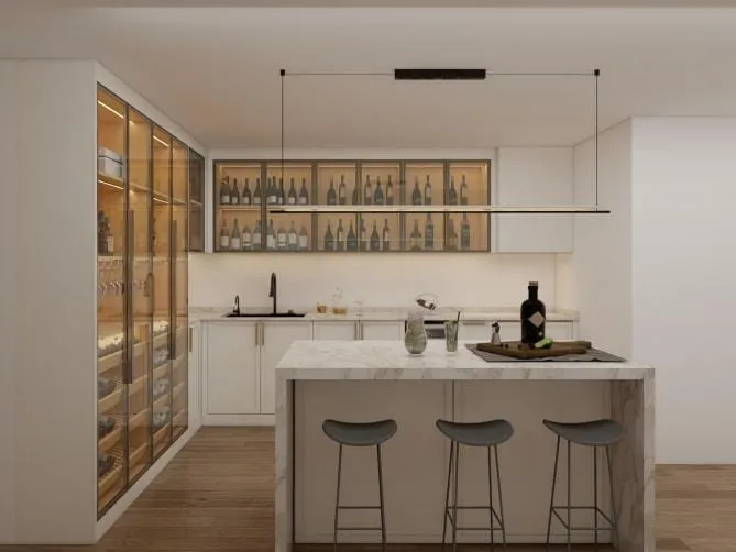 White Shaker kitchen with glass-front wine cabinets, a marble waterfall island and three gray stools