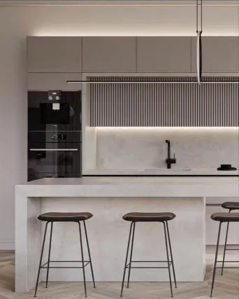 Minimal kitchen with light gray cabinets, a slatted panel, built-in ovens and a white island with three stools