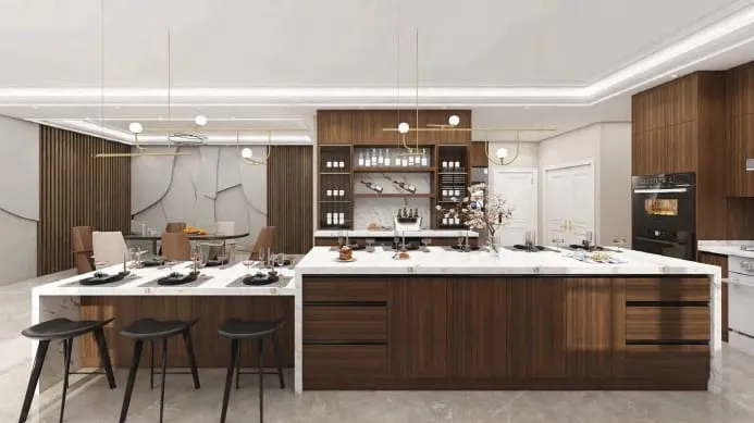 Long walnut island with a lower attached dining table, black stools and a lit display wall