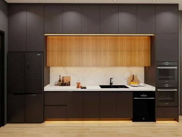 Charcoal cabinet wall with a walnut-tone upper band, marble backsplash, black refrigerator and wall ovens