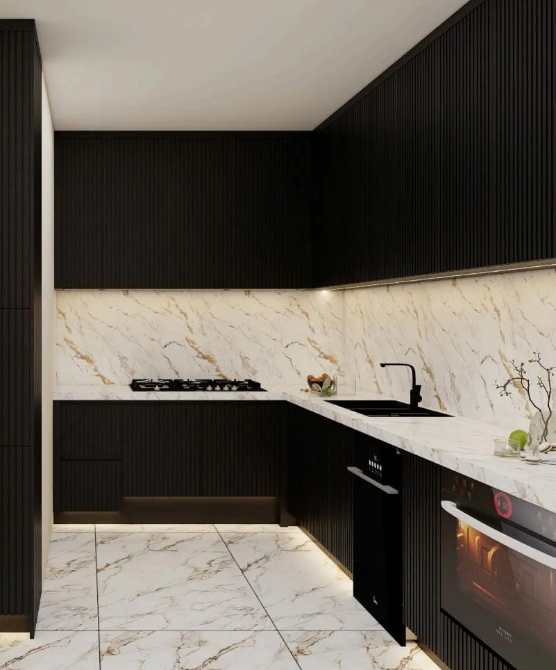 Corner of black fluted cabinets with a marble backsplash, black faucet and built-in oven