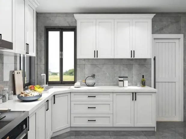 White Shaker cabinets with black pulls, white quartz counters and gray stone-look wall tile by a corner window