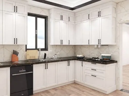 L-shaped white Shaker kitchen with black counters and a window over the sink