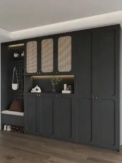 Angled view of charcoal cabinets with arched panels, cane uppers and a pegboard with a hanging bag