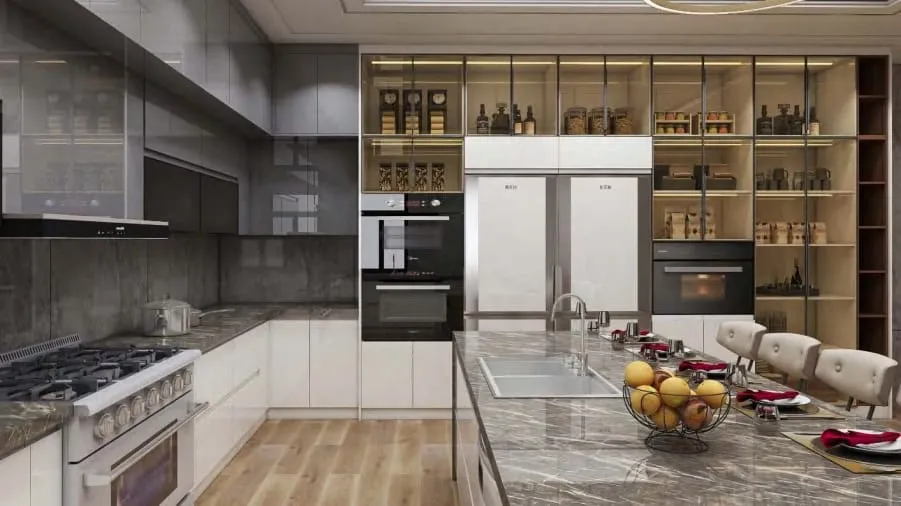 Glass-front pantry wall with a white refrigerator and built-in ovens behind a marble island and range