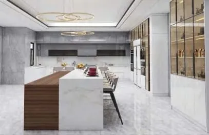 Long view of a white and walnut island with stools and full-height glass display cabinets