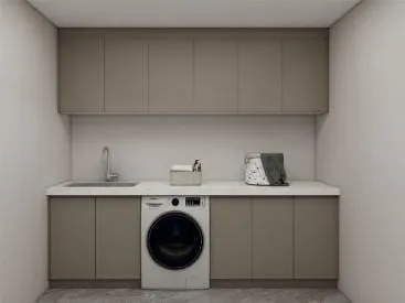 Taupe cabinet run with a front-loading washer under the counter beside a sink