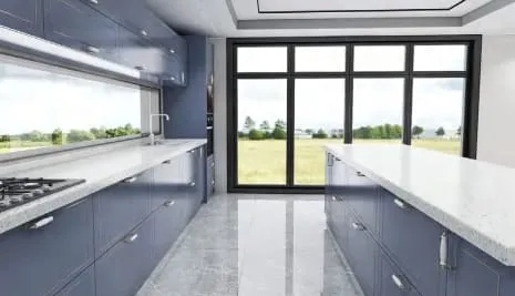 Galley between blue cabinets and a white island leading to tall glass doors