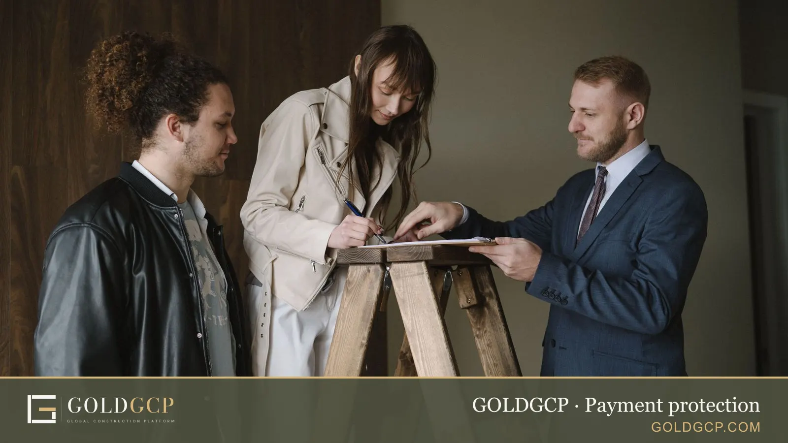 Three people signing a contract inside a new house