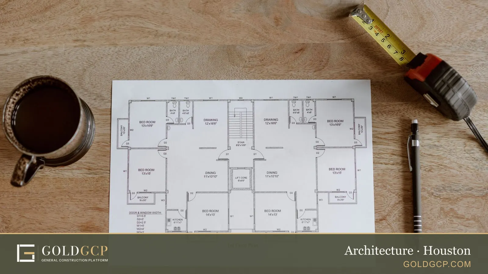 A printed first-floor house plan with a tape measure, a pen and a coffee cup on a wooden table
