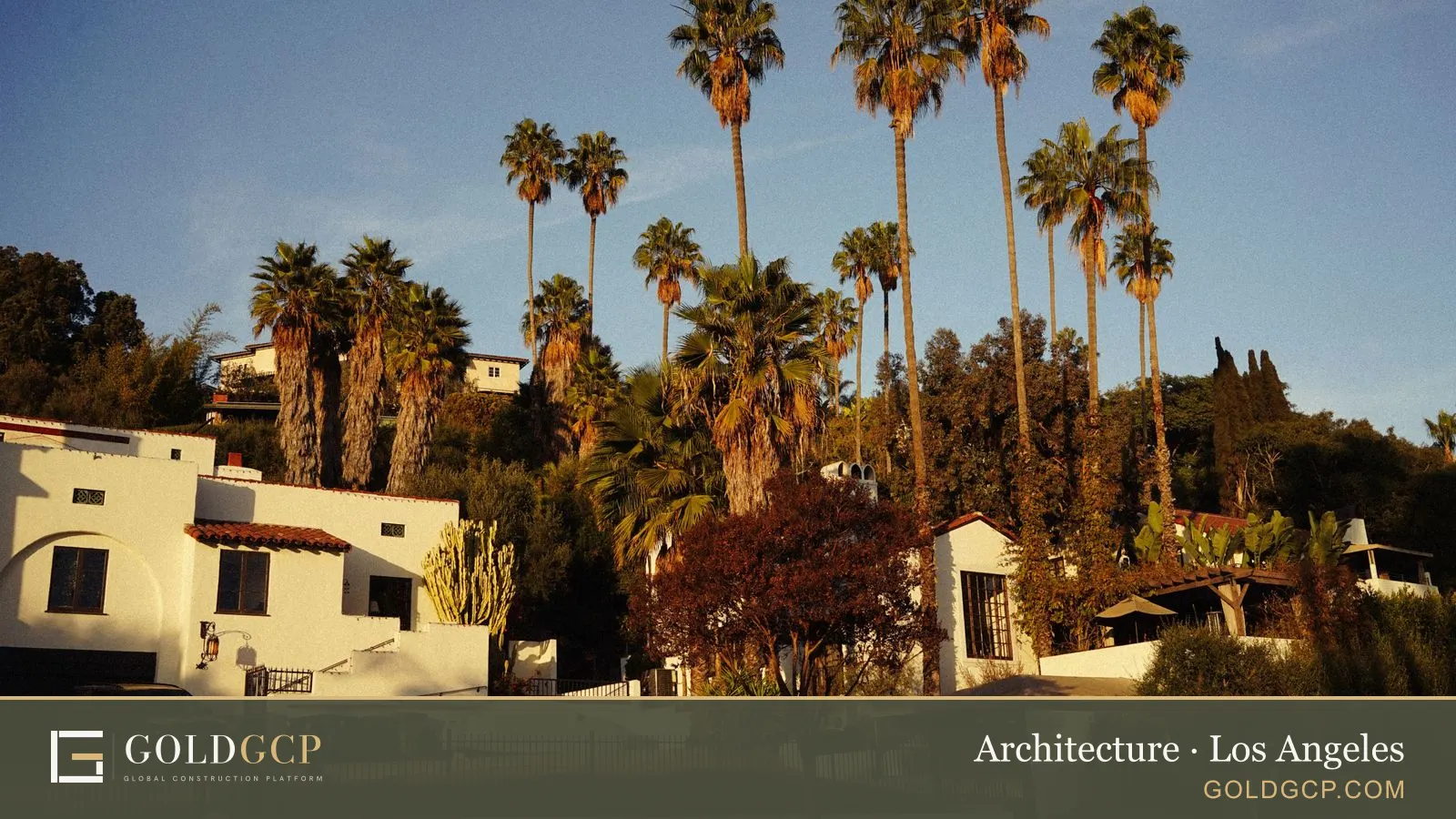 Spanish-style houses and tall palm trees in Southern California at sunset