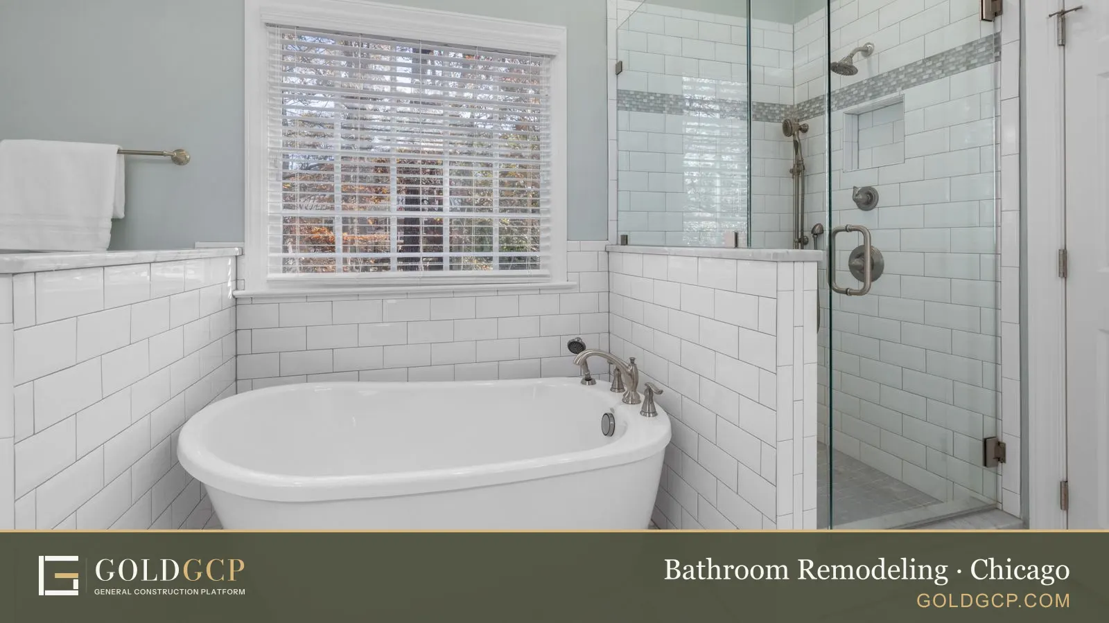 A remodeled bathroom with white subway tile, a freestanding tub and a glass shower