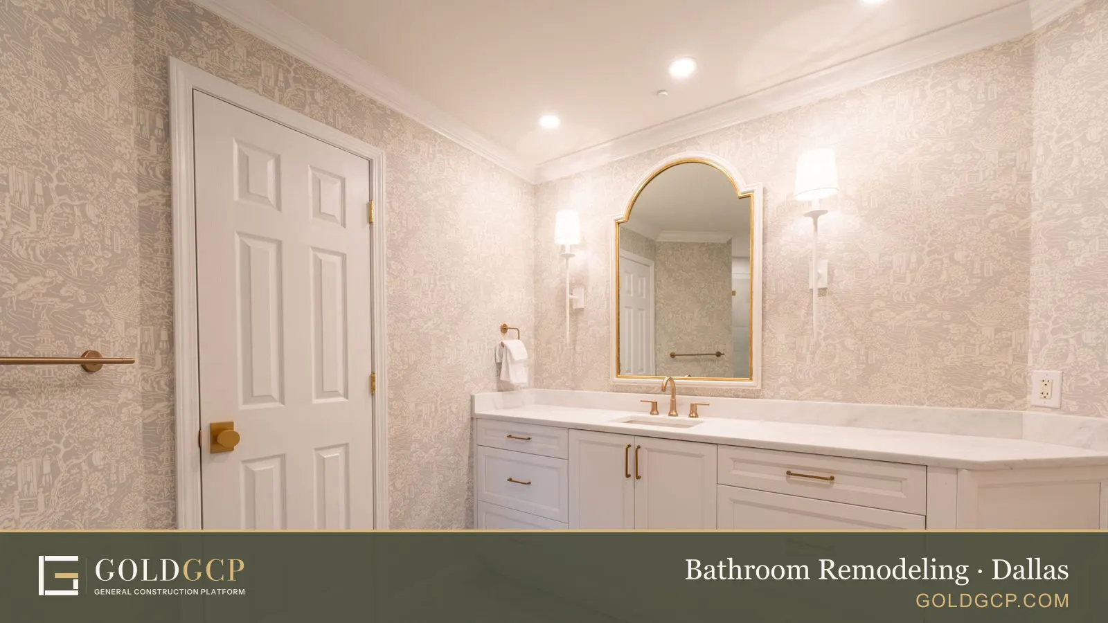A remodeled bathroom with a white vanity, brass fixtures and an arched mirror