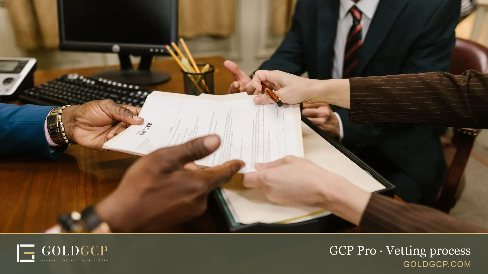 People reviewing and signing documents at a meeting table