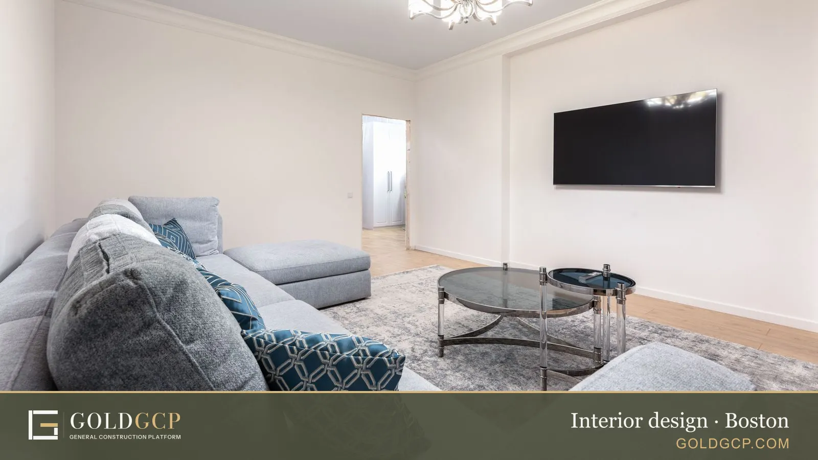 Contemporary room interior with a couch, a TV with a black screen on tables, and a shiny chandelier