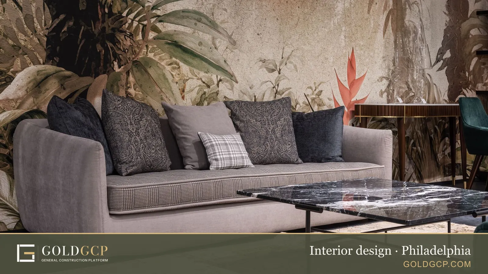 Comfortable sofa with pillows against a wall with painted leaves in a modern room with a table on a rug