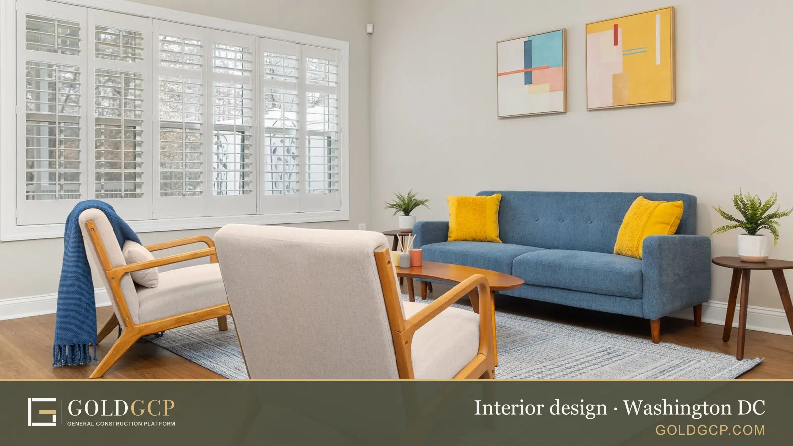Stylish living room with a blue sofa, abstract art, and natural light from large windows.