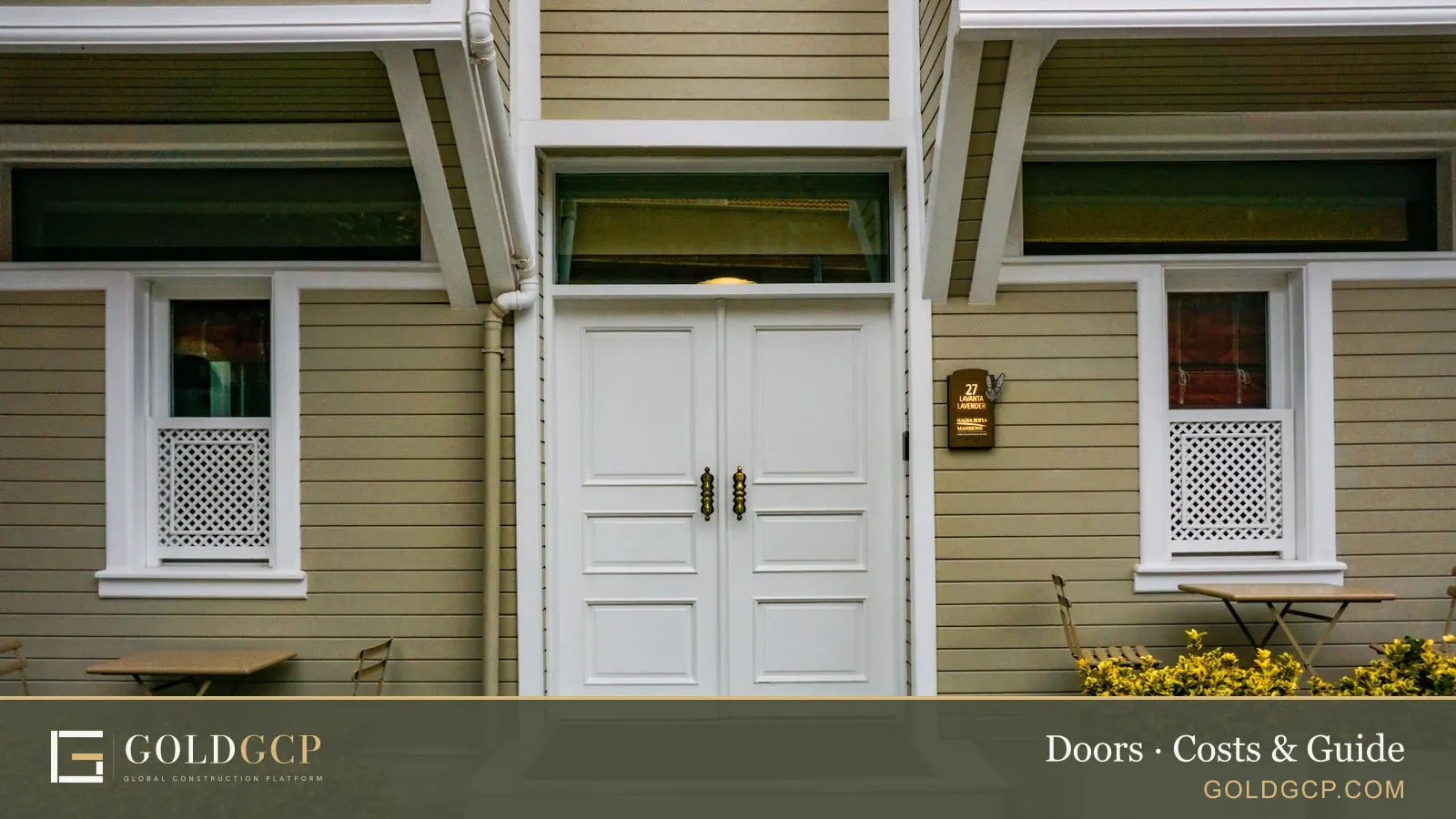 The entrance of a house with white double front doors