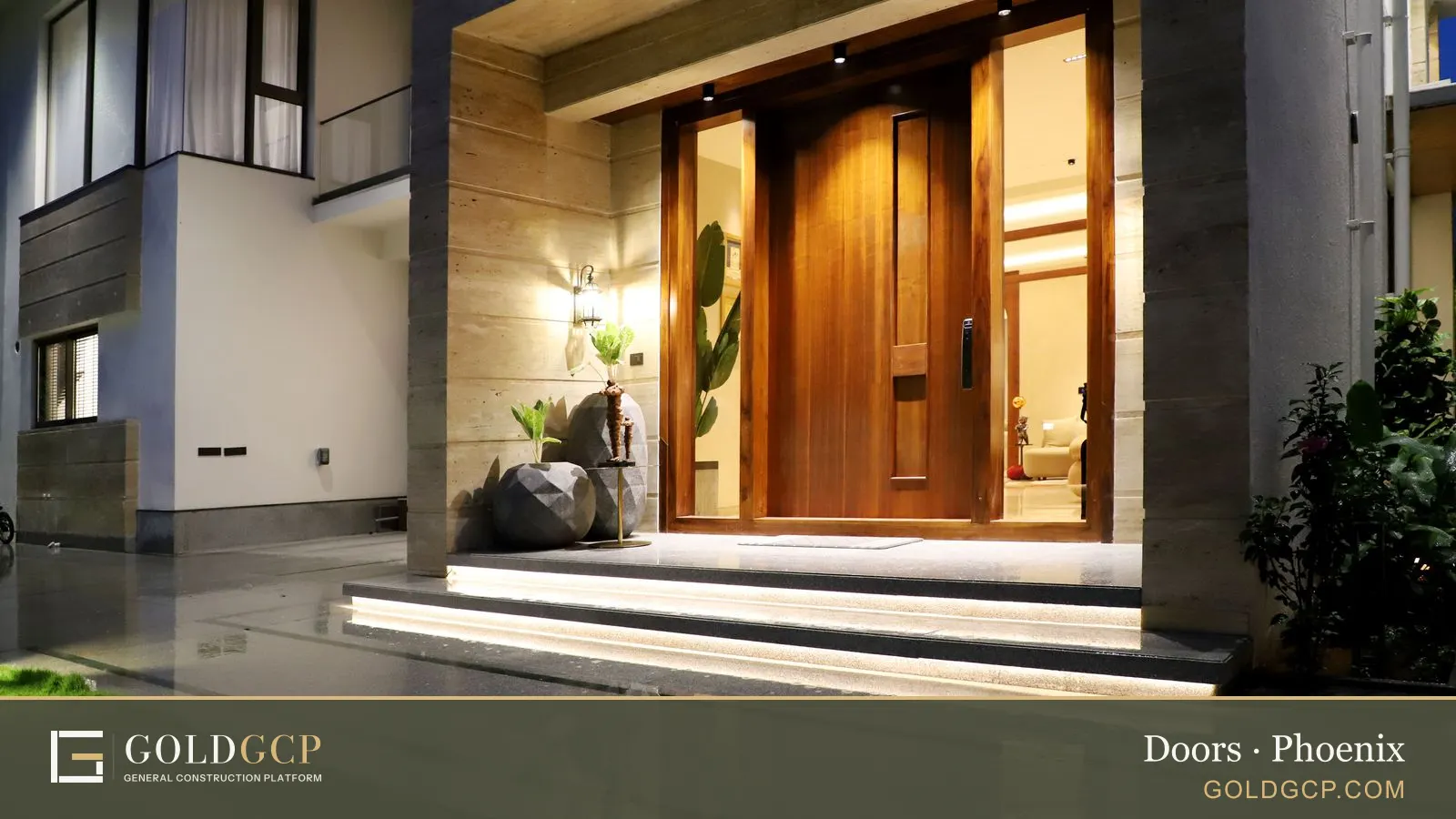 Modern house entrance at night with a tall wooden front door and warm lighting