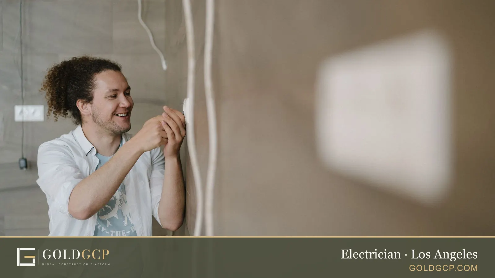 An electrician adjusting an outlet inside a home