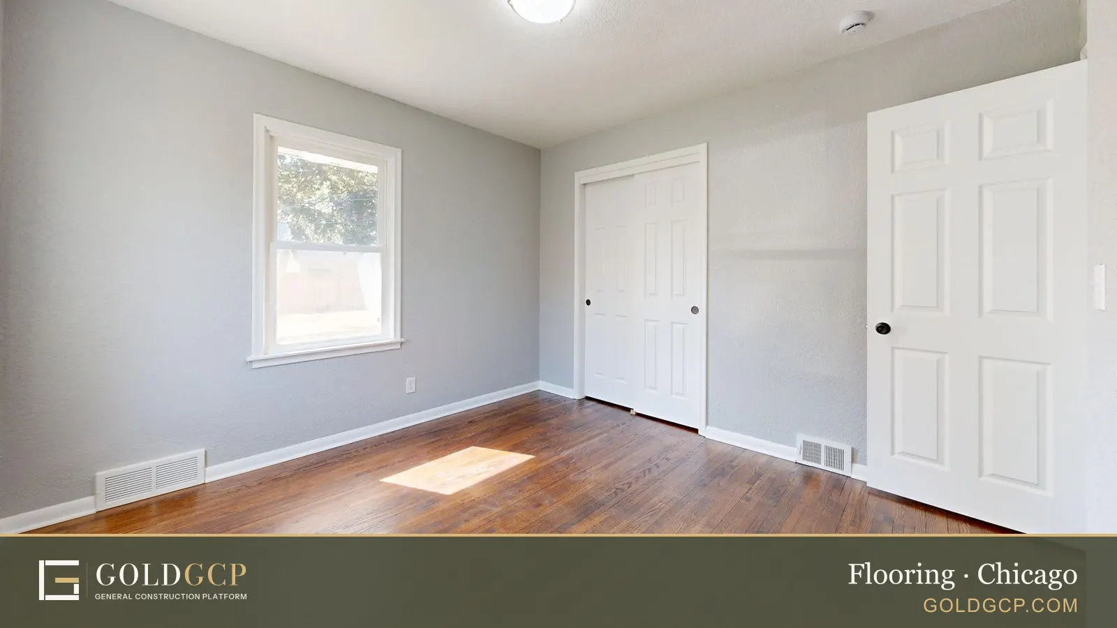 Spacious empty room with hardwood floors and sunlight streaming through the window.
