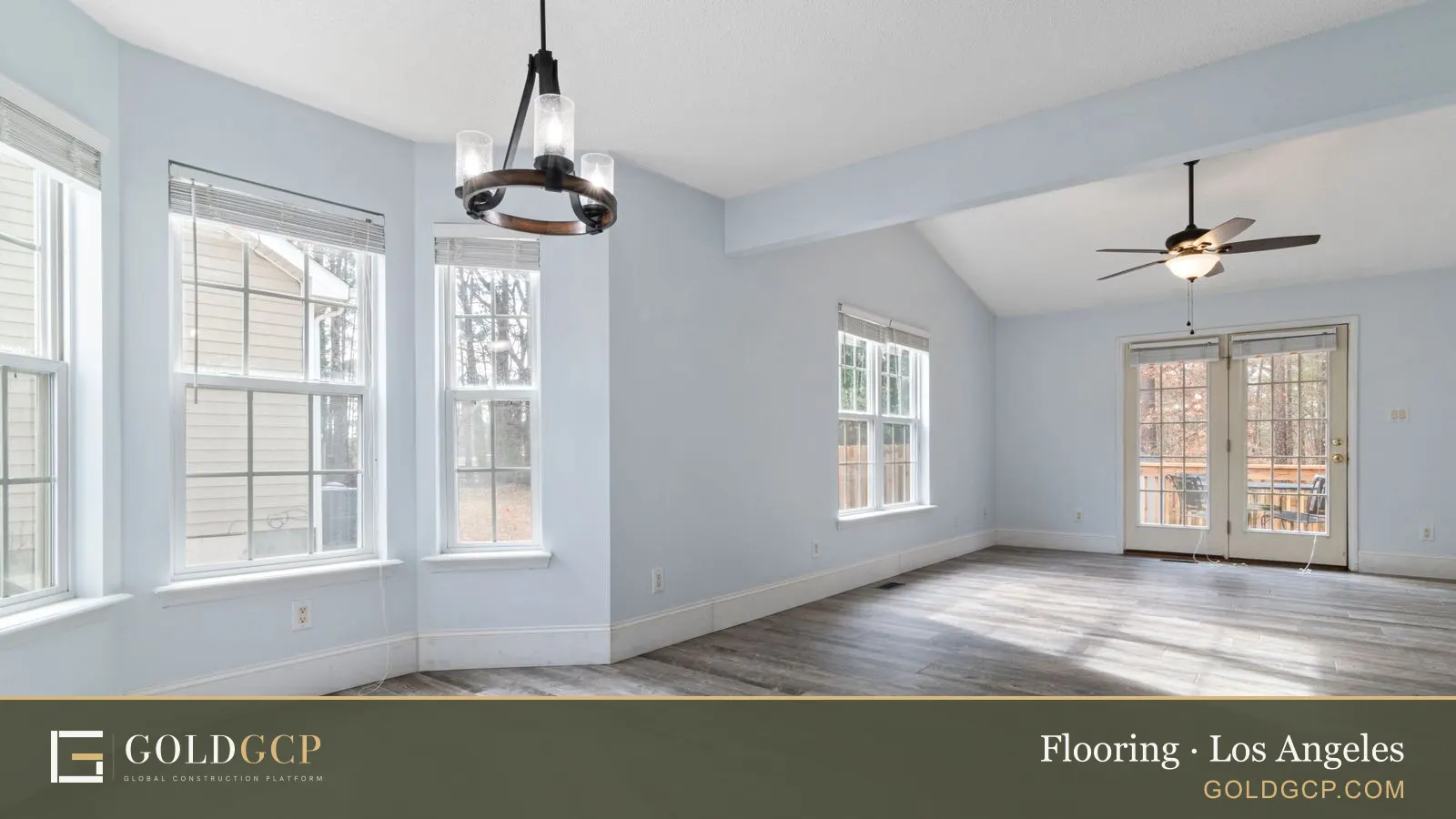 An empty living room with new wood floors and natural light