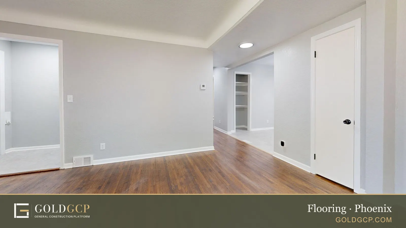 Bright empty room with wooden floor, suitable for real estate listings.