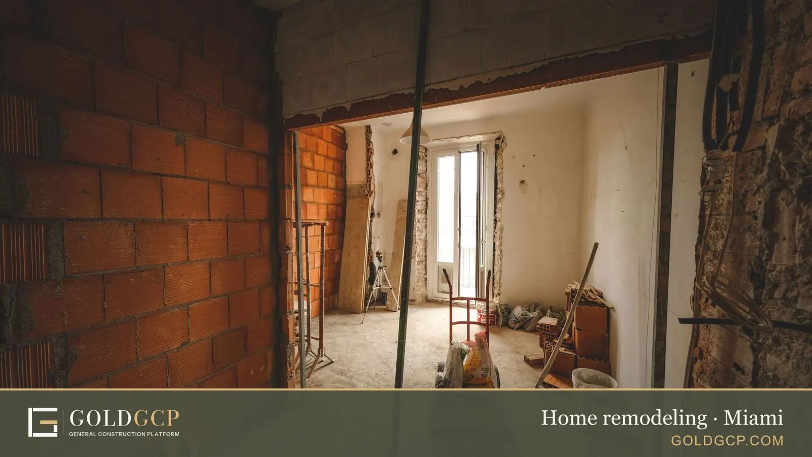 Partially renovated room with exposed brick walls and construction materials on site.