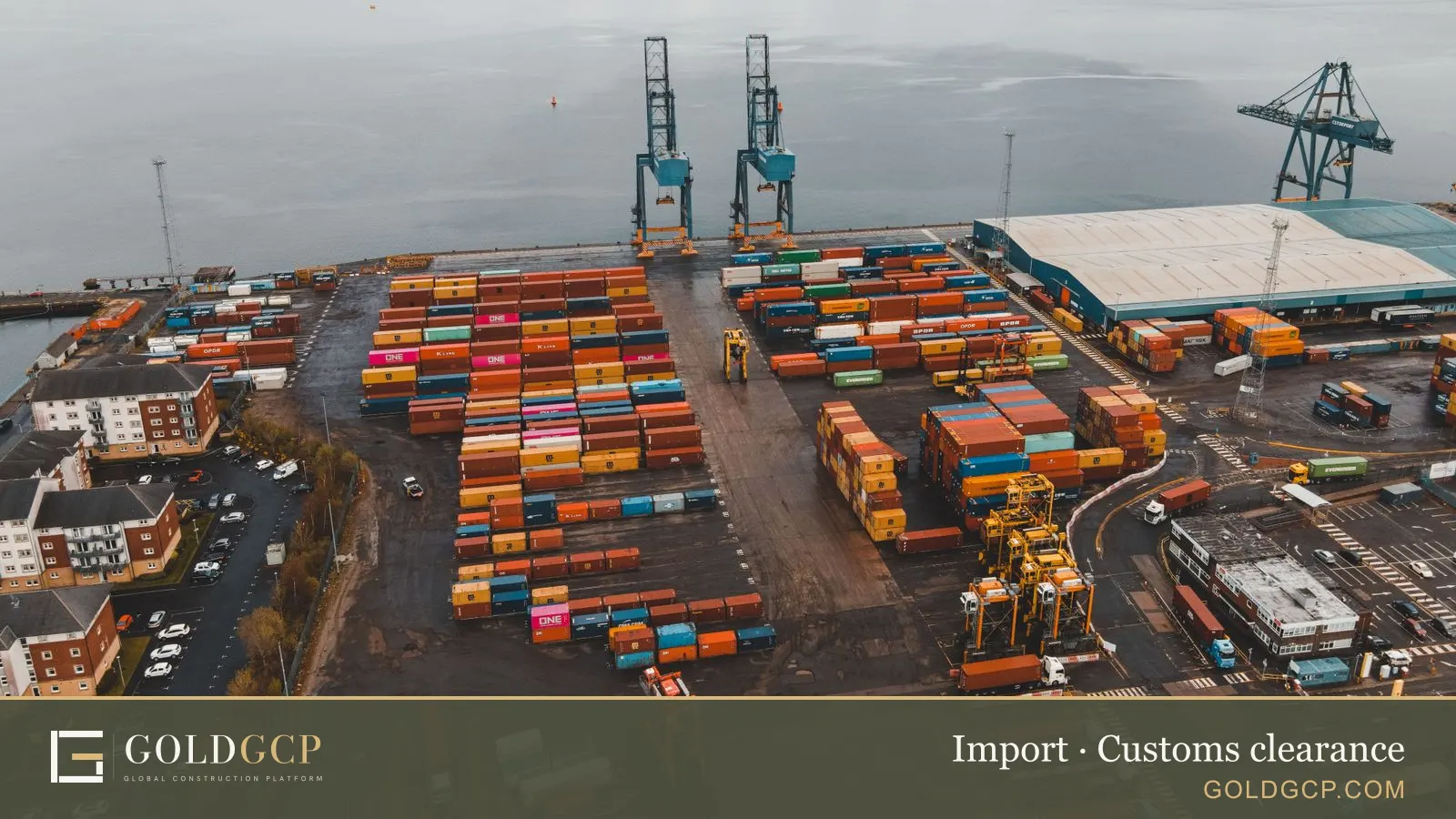 Aerial view of a container port with cranes and stacked containers
