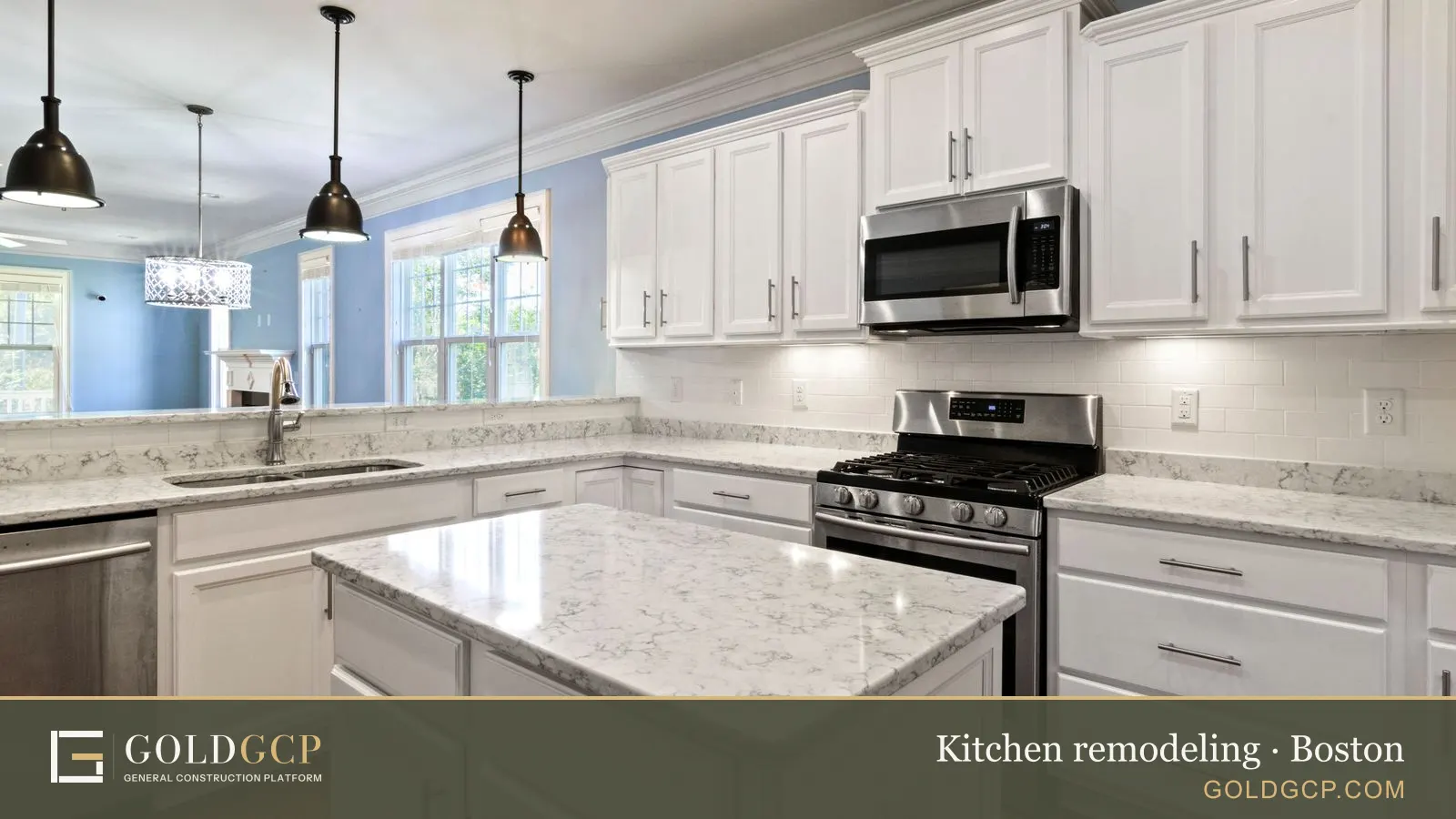 Bright spacious kitchen with marble countertops, stainless steel appliances, and white cabinetry.