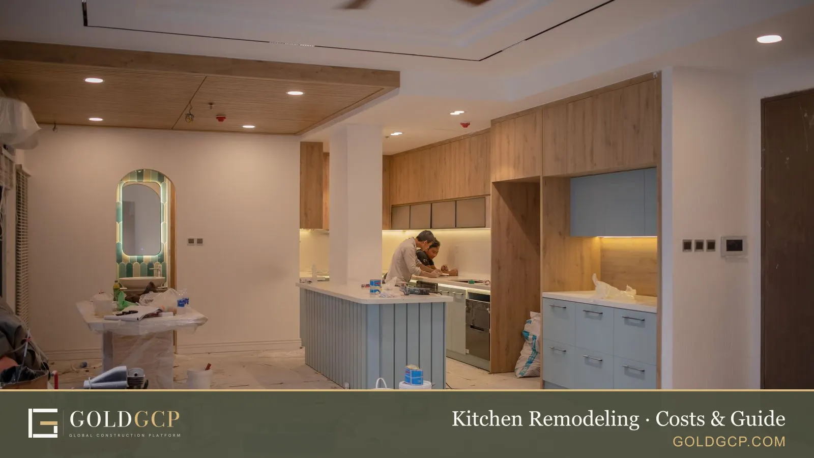 A worker installing cabinets in a kitchen during a renovation