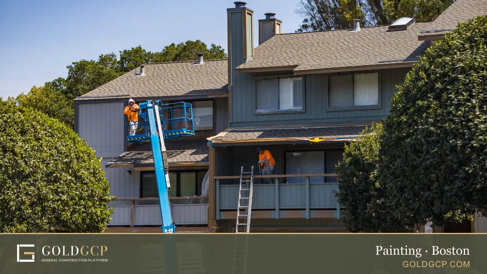 Painters on a lift and a ladder working on the exterior of a two-story townhouse.