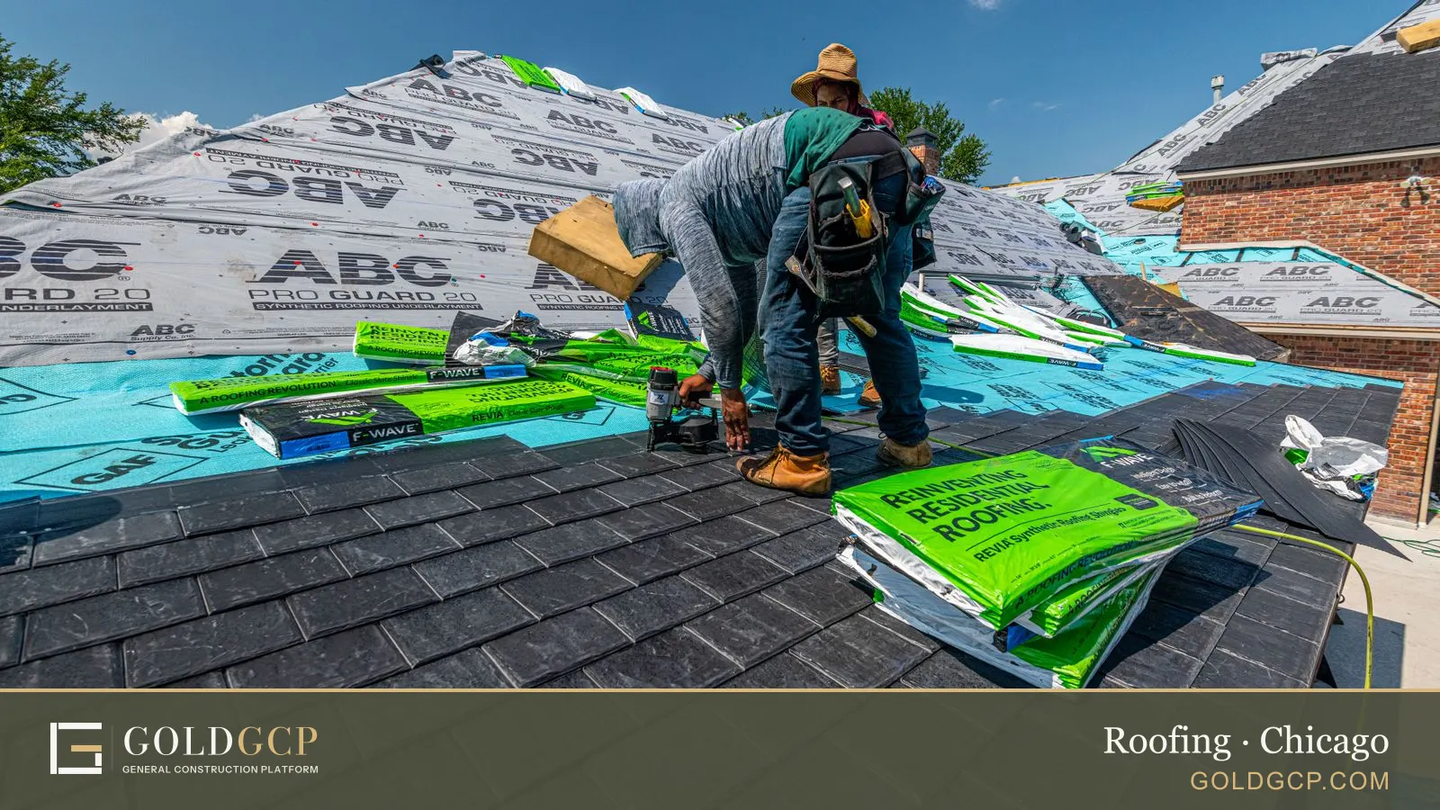 Roofers laying new shingles over fresh underlayment on a brick house