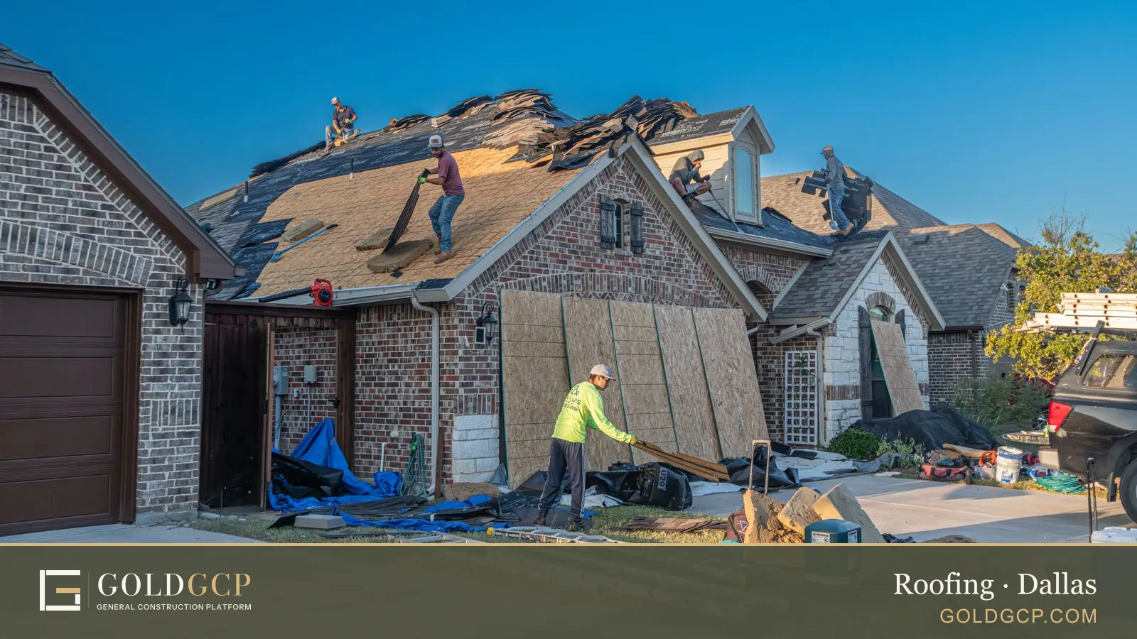 A crew replacing the shingle roof of a brick house in North Texas