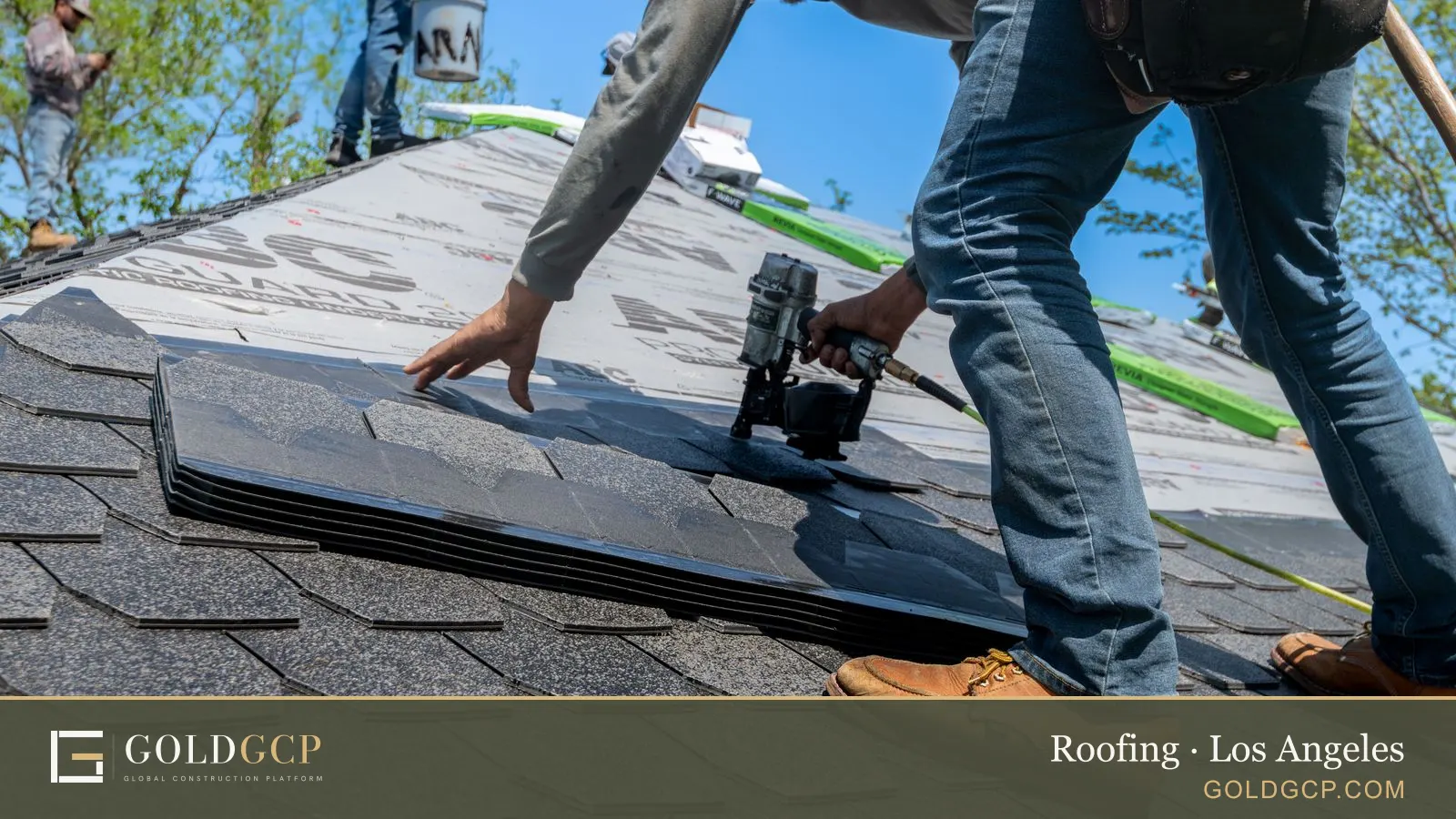 A roofer using a nail gun to install shingles on a house