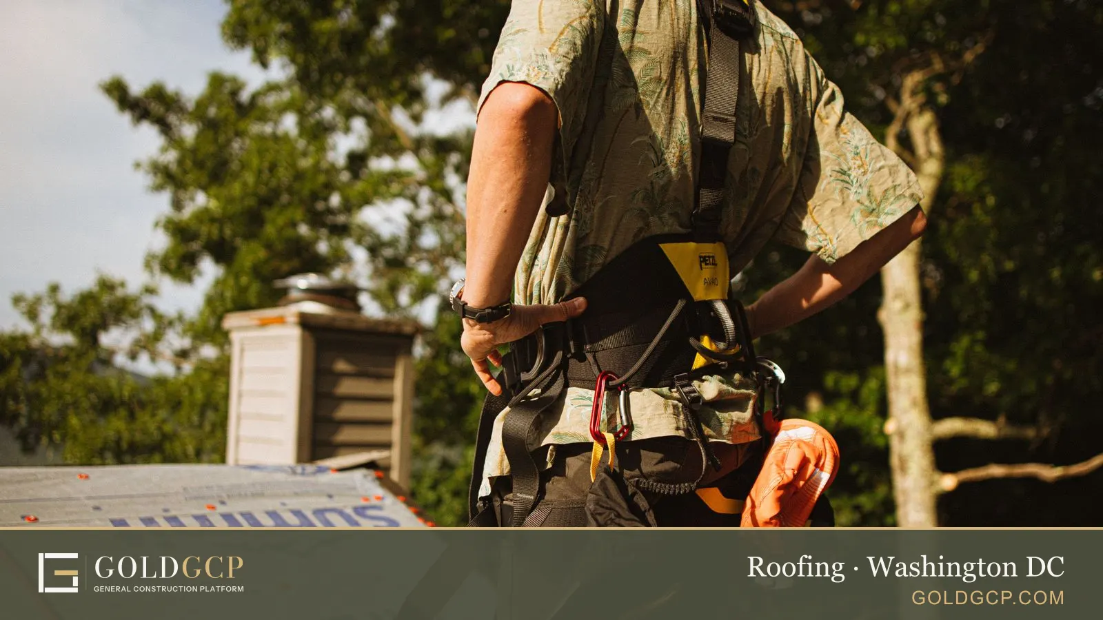 Construction worker wearing a safety harness on a rooftop.