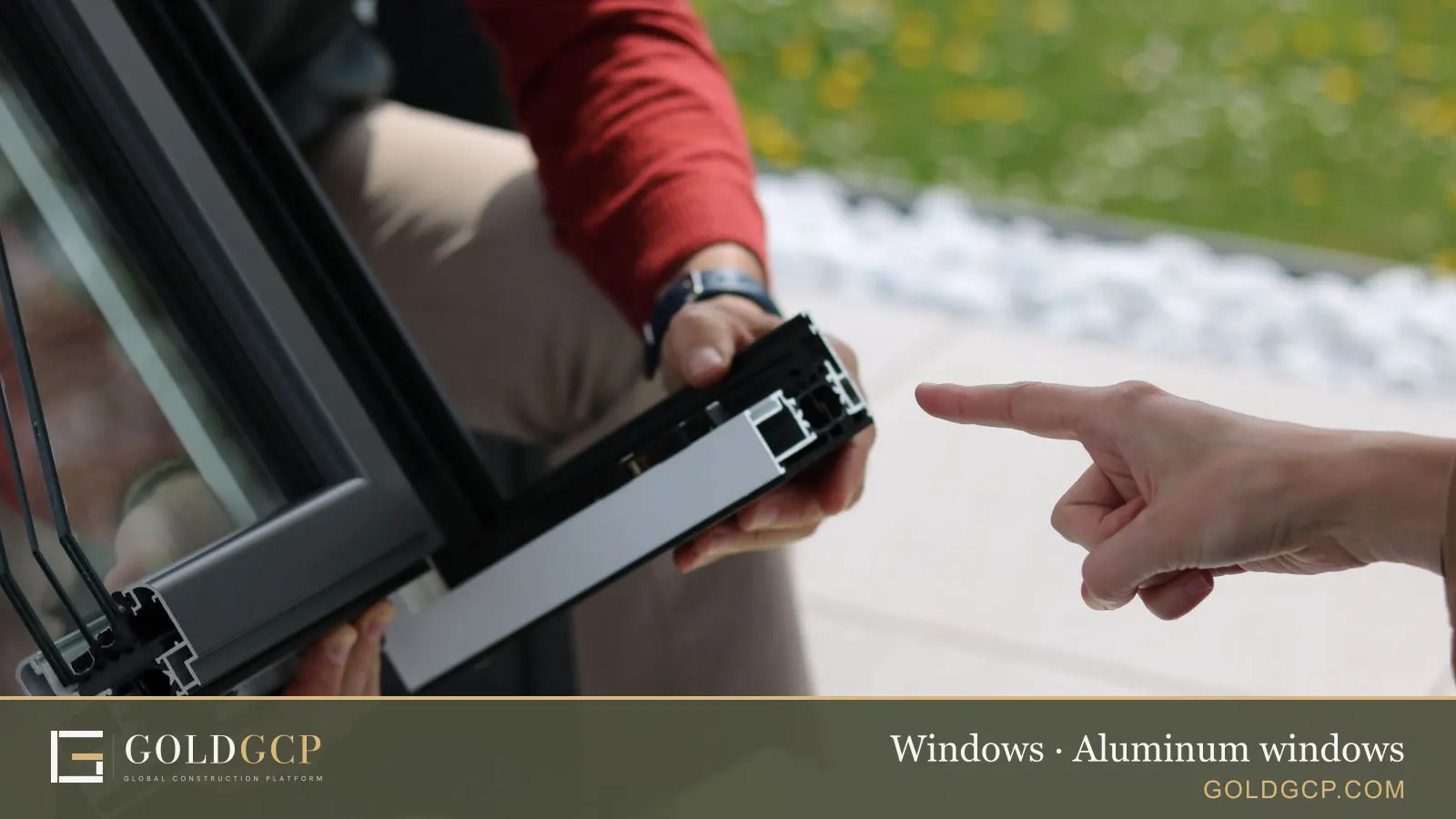 Two people examining an aluminum window frame outdoors