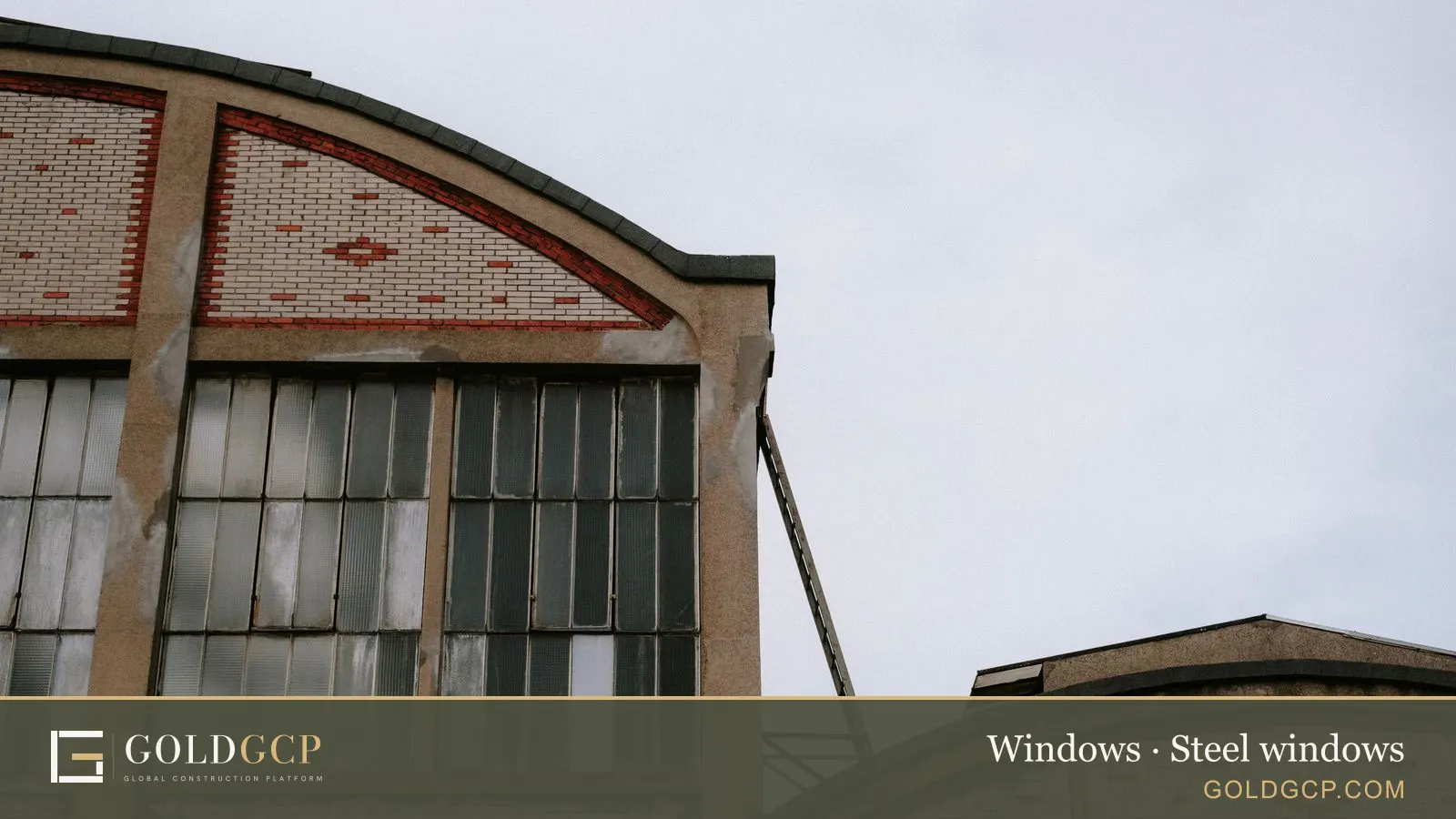 Large steel-framed windows on a red brick factory building