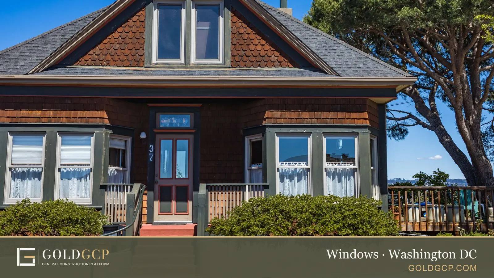 An older house with bay windows, green trim and red front steps